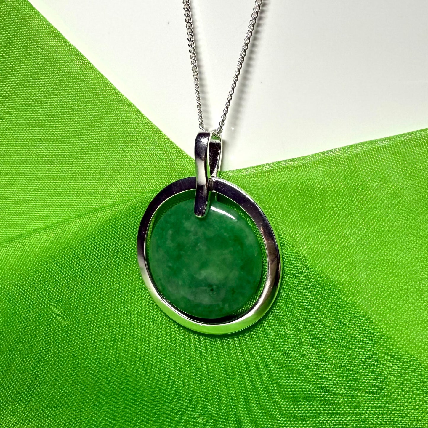 Large silver round shaped dark green real jade necklace with a chain