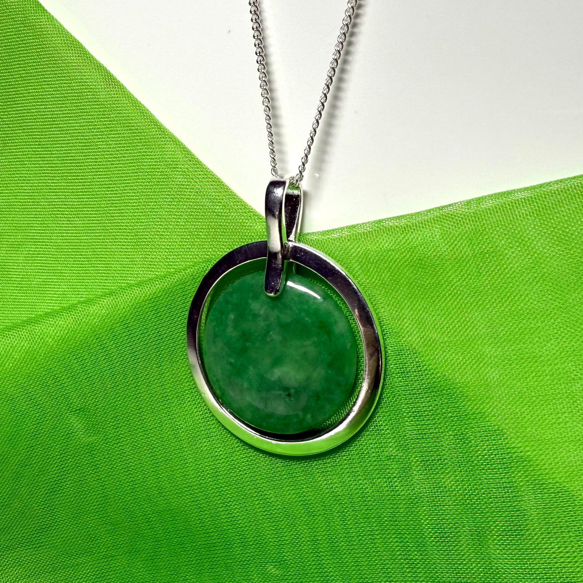Large silver round shaped dark green real jade necklace with a chain