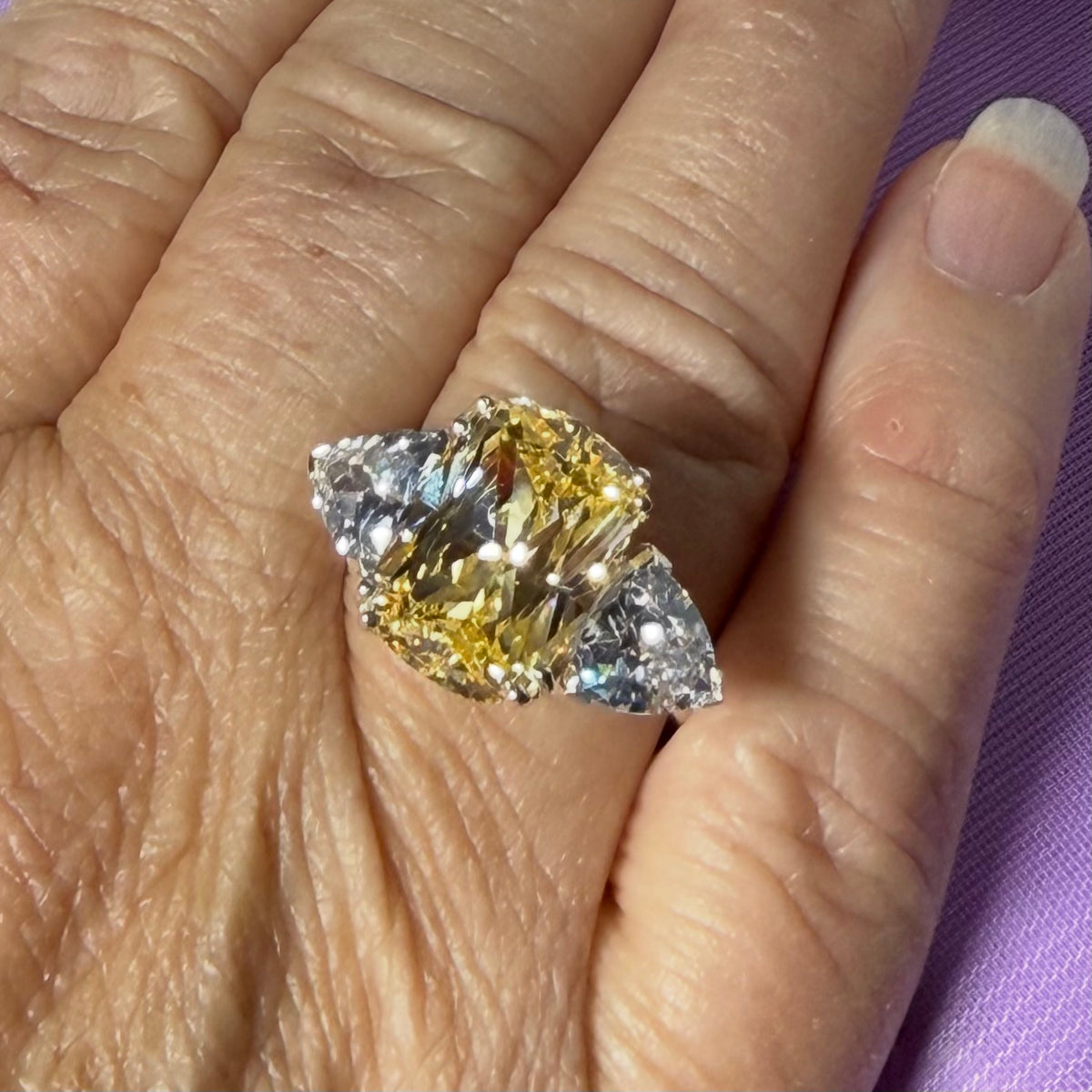 Large yellow lemon coloured cocktail ring on the finger