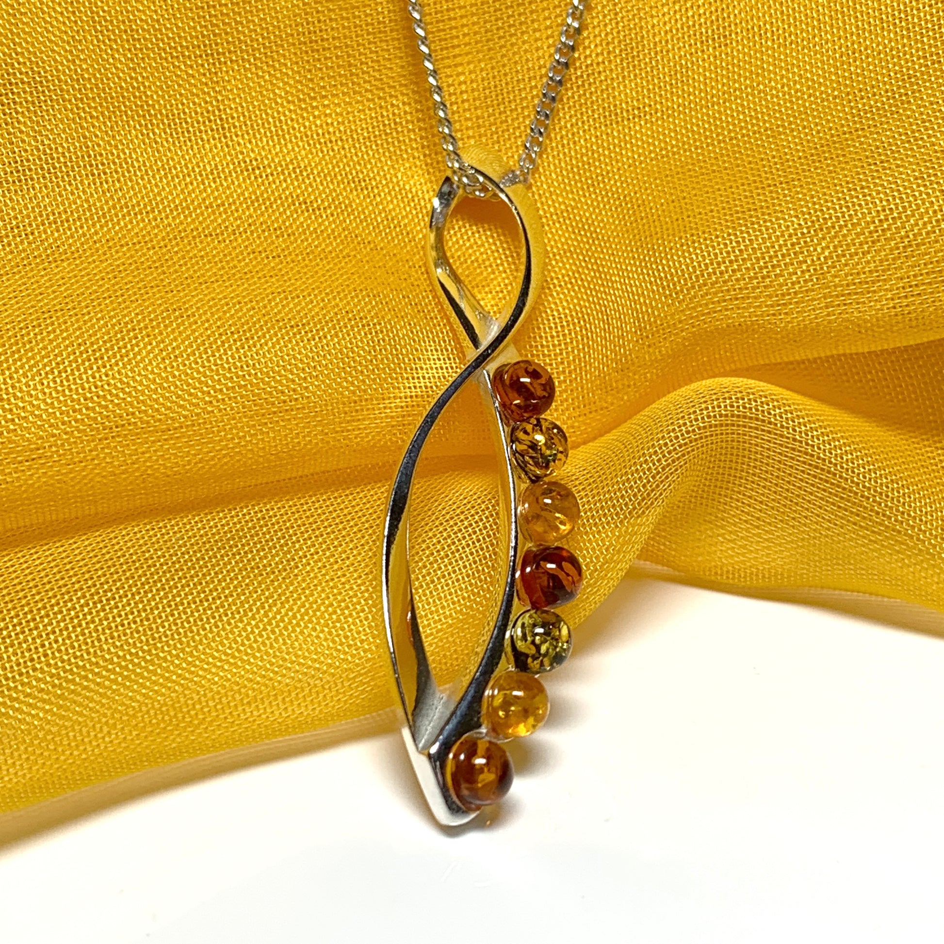 Multi colour amber figure of eight drop sterling silver necklace