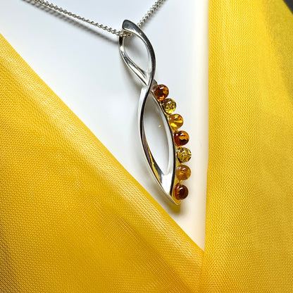 Multi colour amber figure of eight drop sterling silver necklace