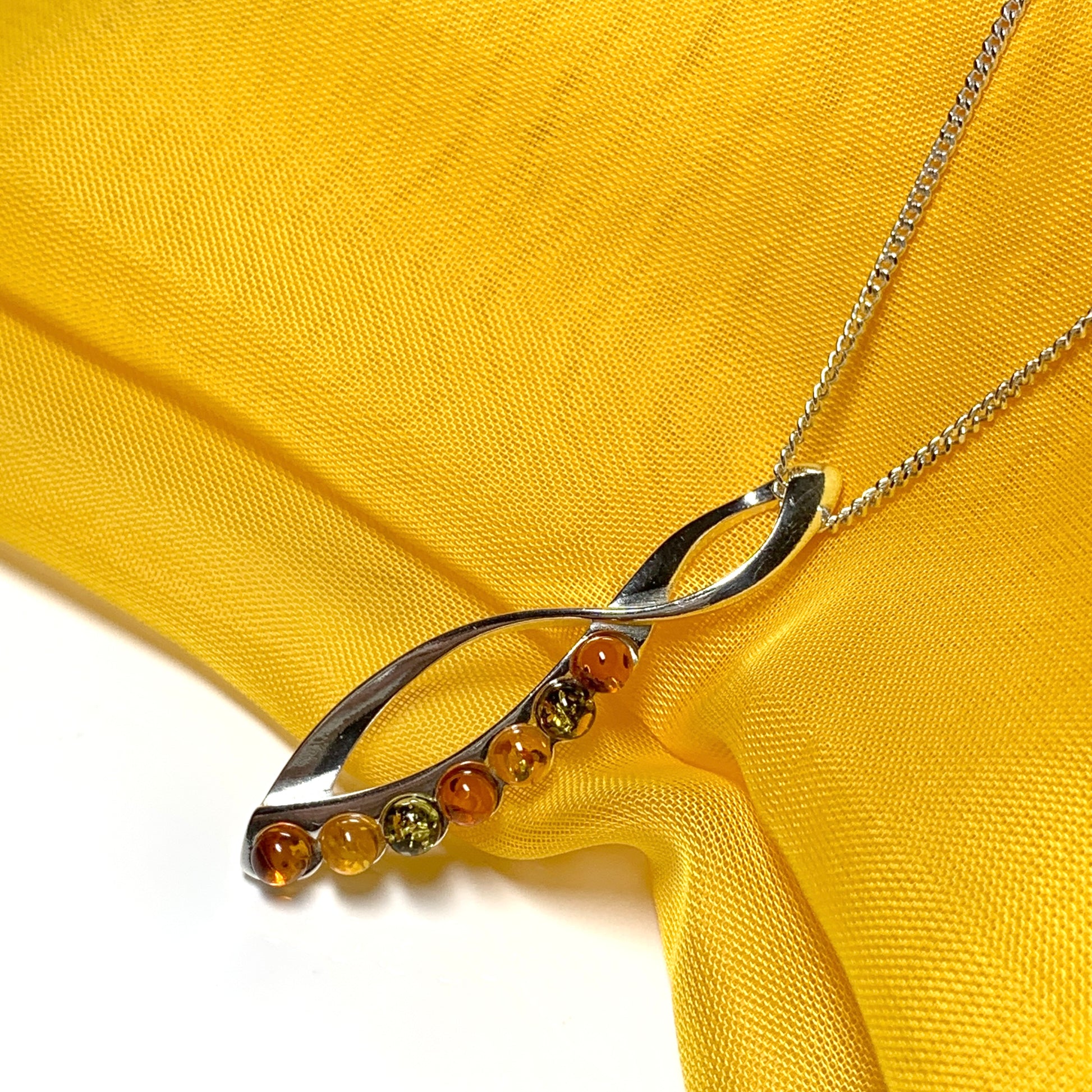 Multi colour amber figure of eight drop sterling silver necklace