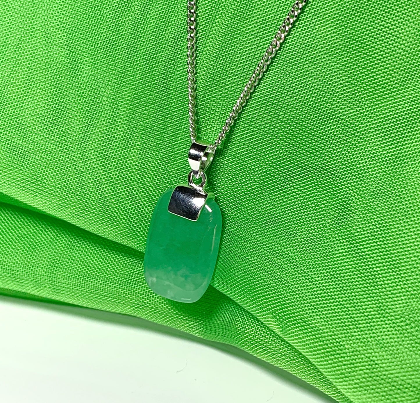 Pendant necklace having a real green jade sterling silver cushion shaped