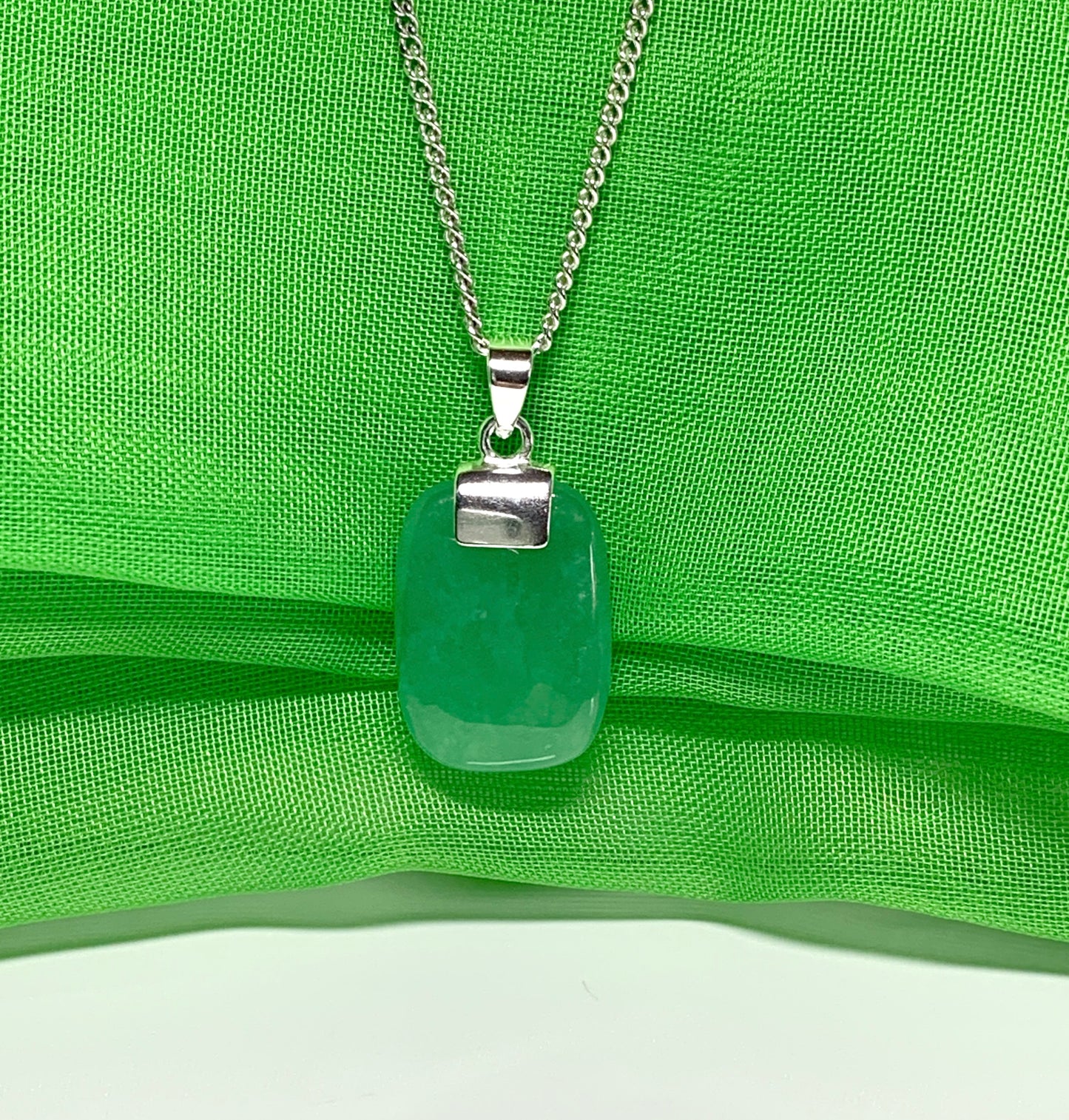 Necklace pendant having a real green jade sterling silver cushion shaped