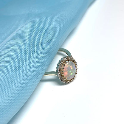 Opal oval and diamond yellow gold cluster ring