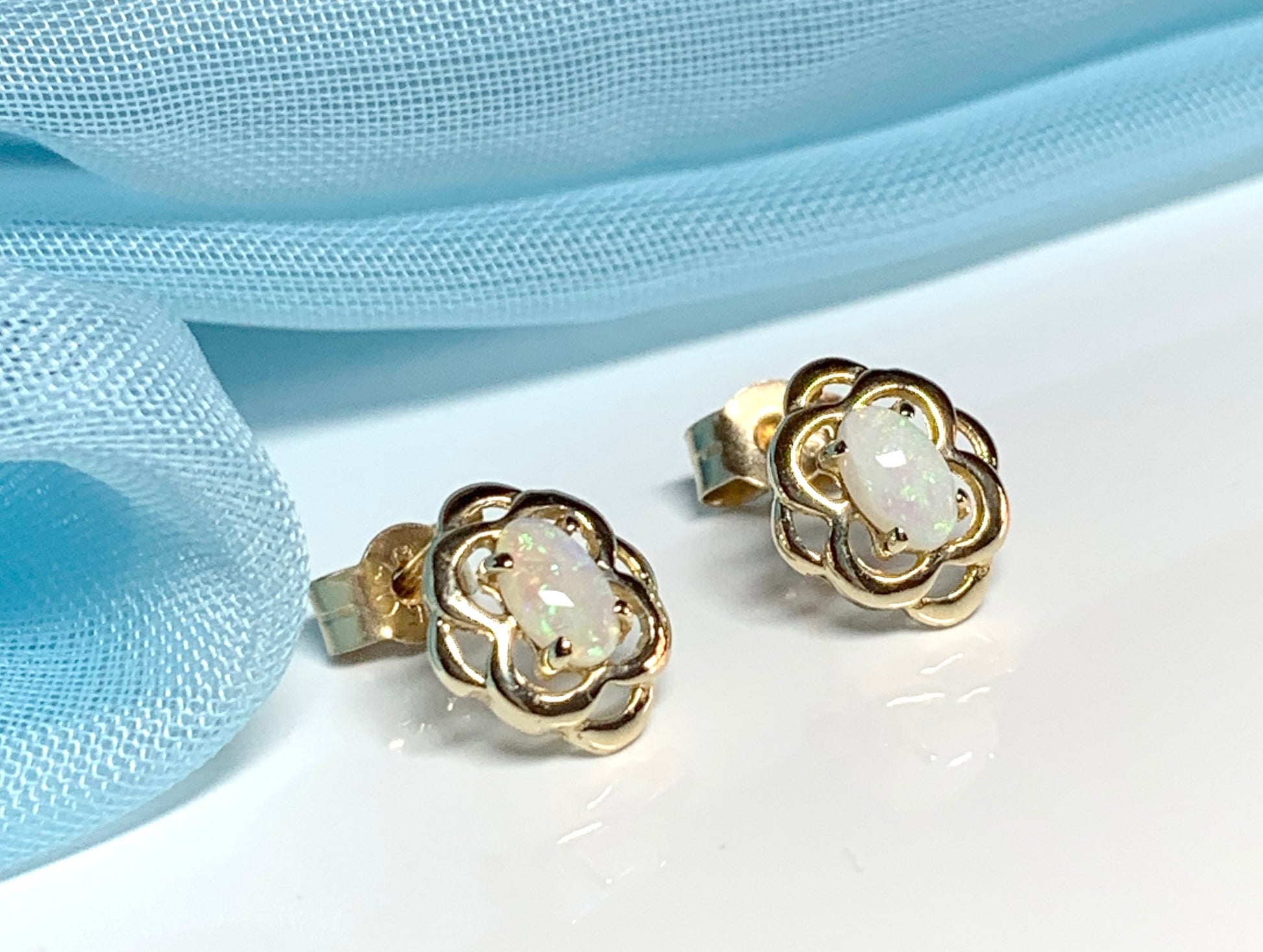 Opal yellow gold emerald stud earrings oval shaped scroll design