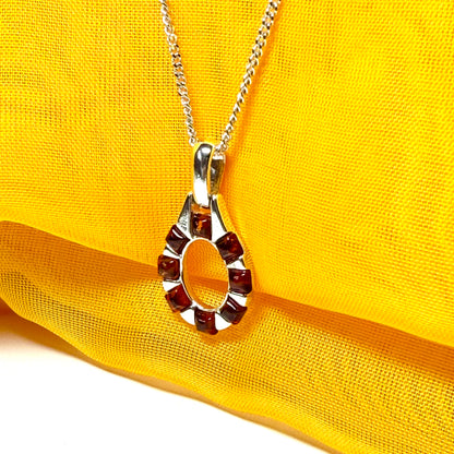 Open oval amber necklace sterling silver pendant