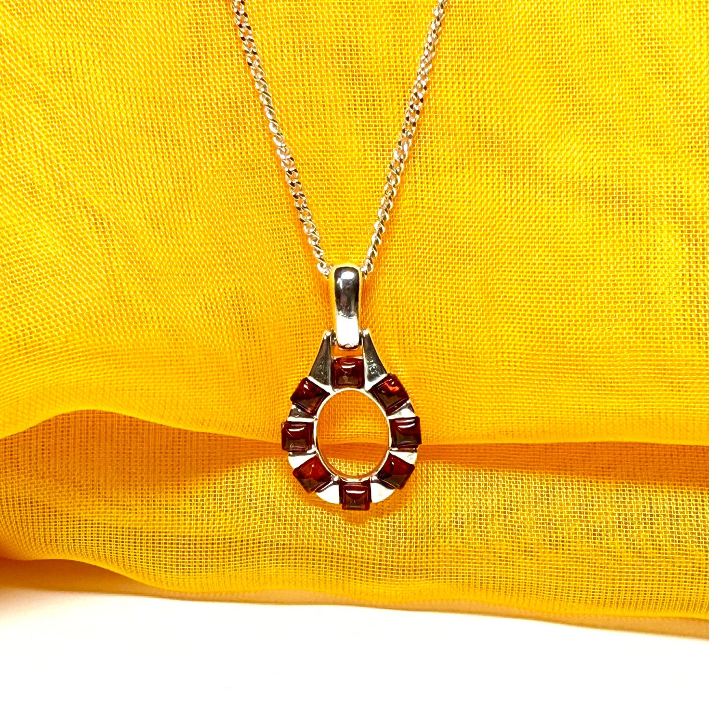 Open oval amber necklace sterling silver pendant