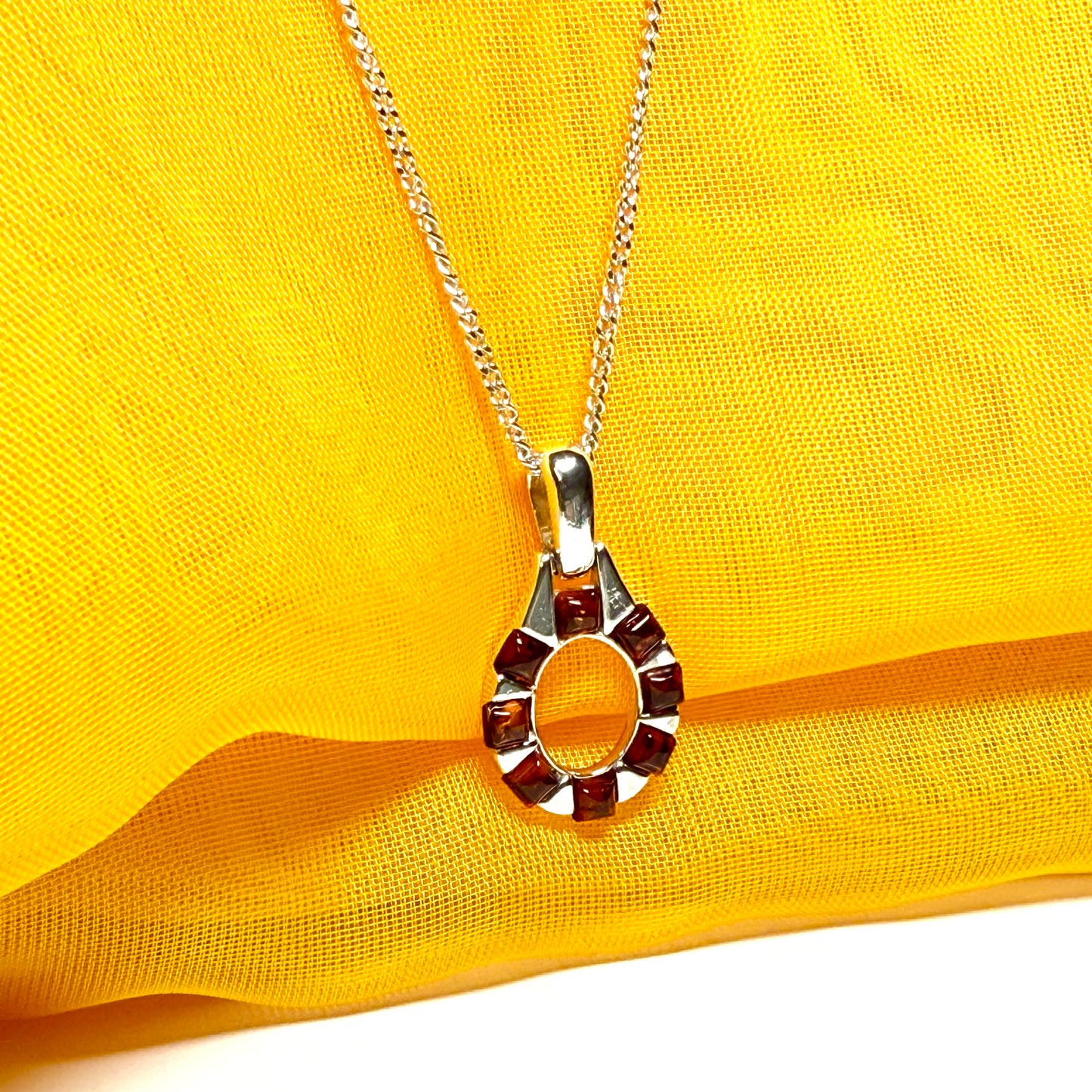 Open oval amber necklace sterling silver pendant