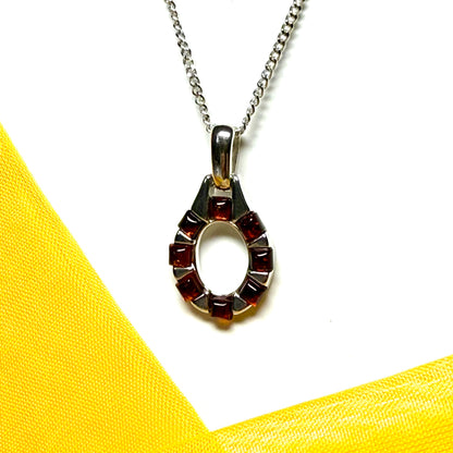 Open oval amber necklace sterling silver pendant