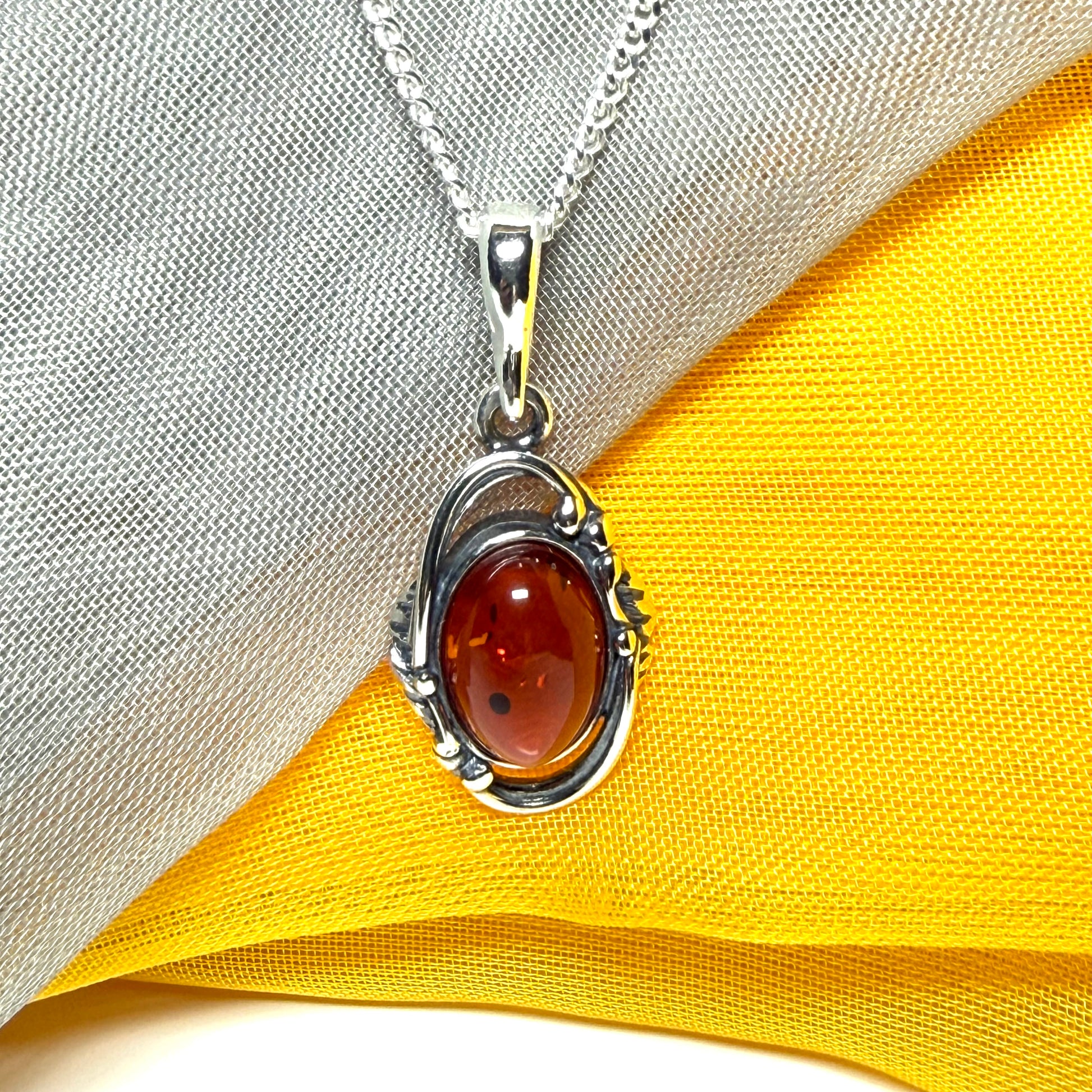 Orange real amber oval sterling silver necklace with a swirl set open pendant With chain