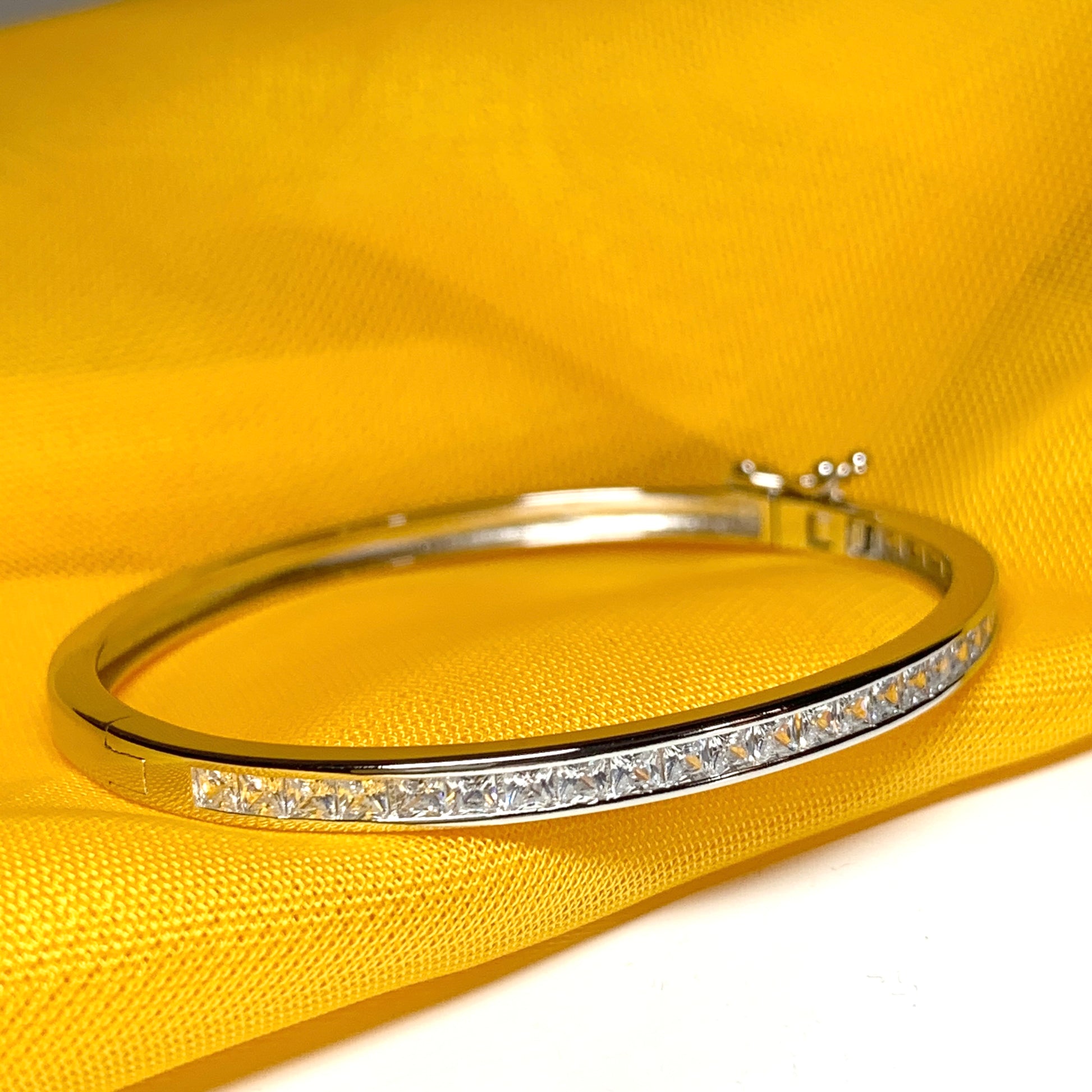 Child's Oval Bangle with Princess Cut Cubic Zirconia Sterling Silver Channel Set