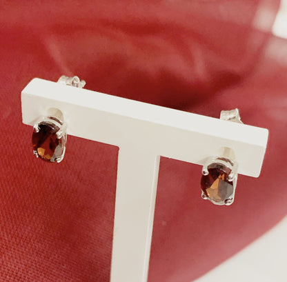 Oval garnet white gold stud earrings