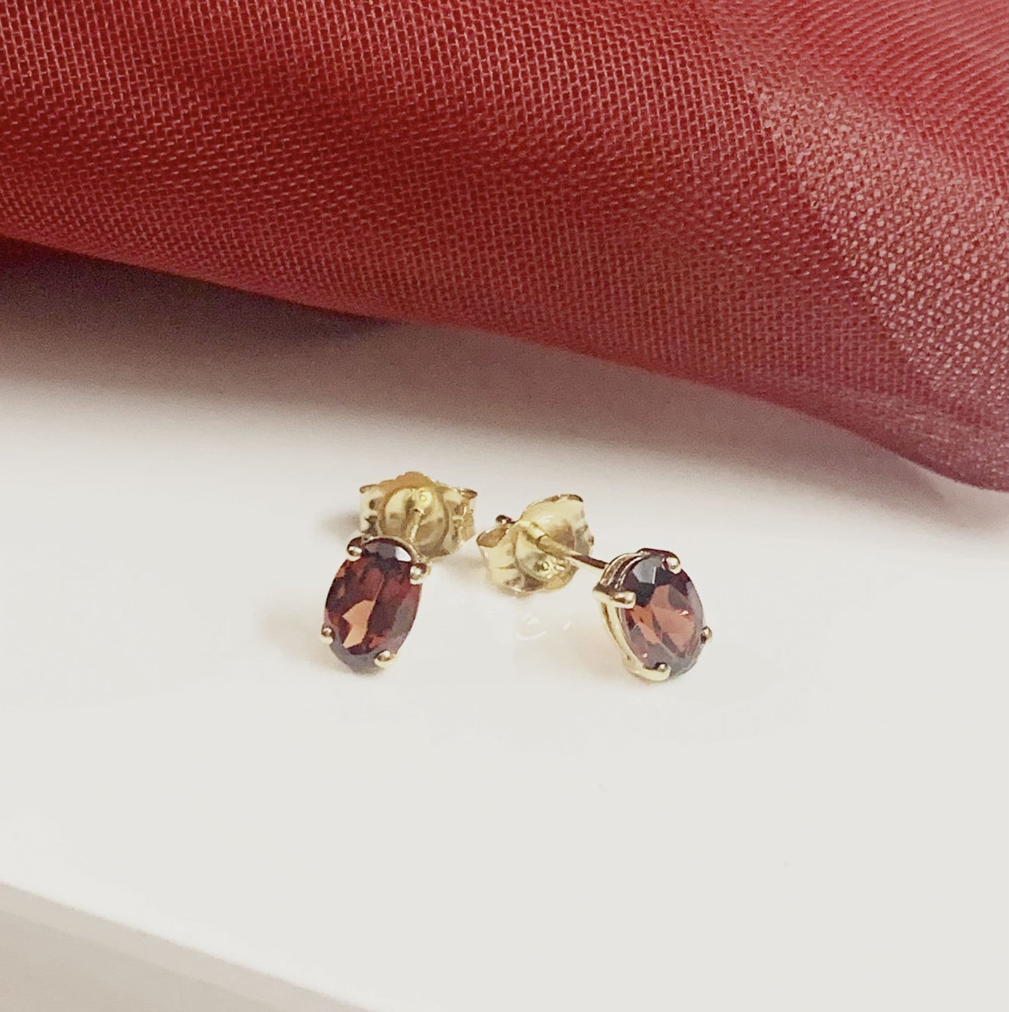 Oval garnet yellow gold stud earrings