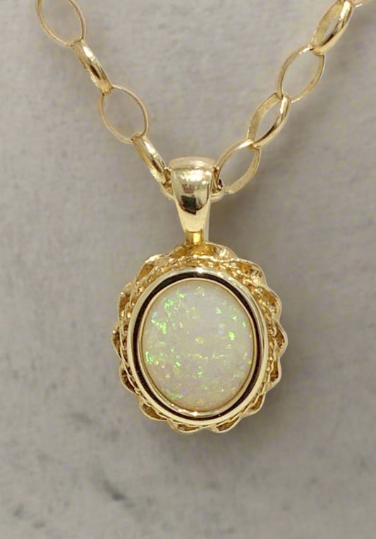 Oval real opal yellow gold necklace with a roped edge