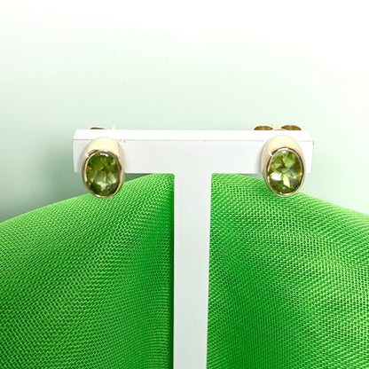 Oval Shaped Peridot Yellow Gold Stud Earrings