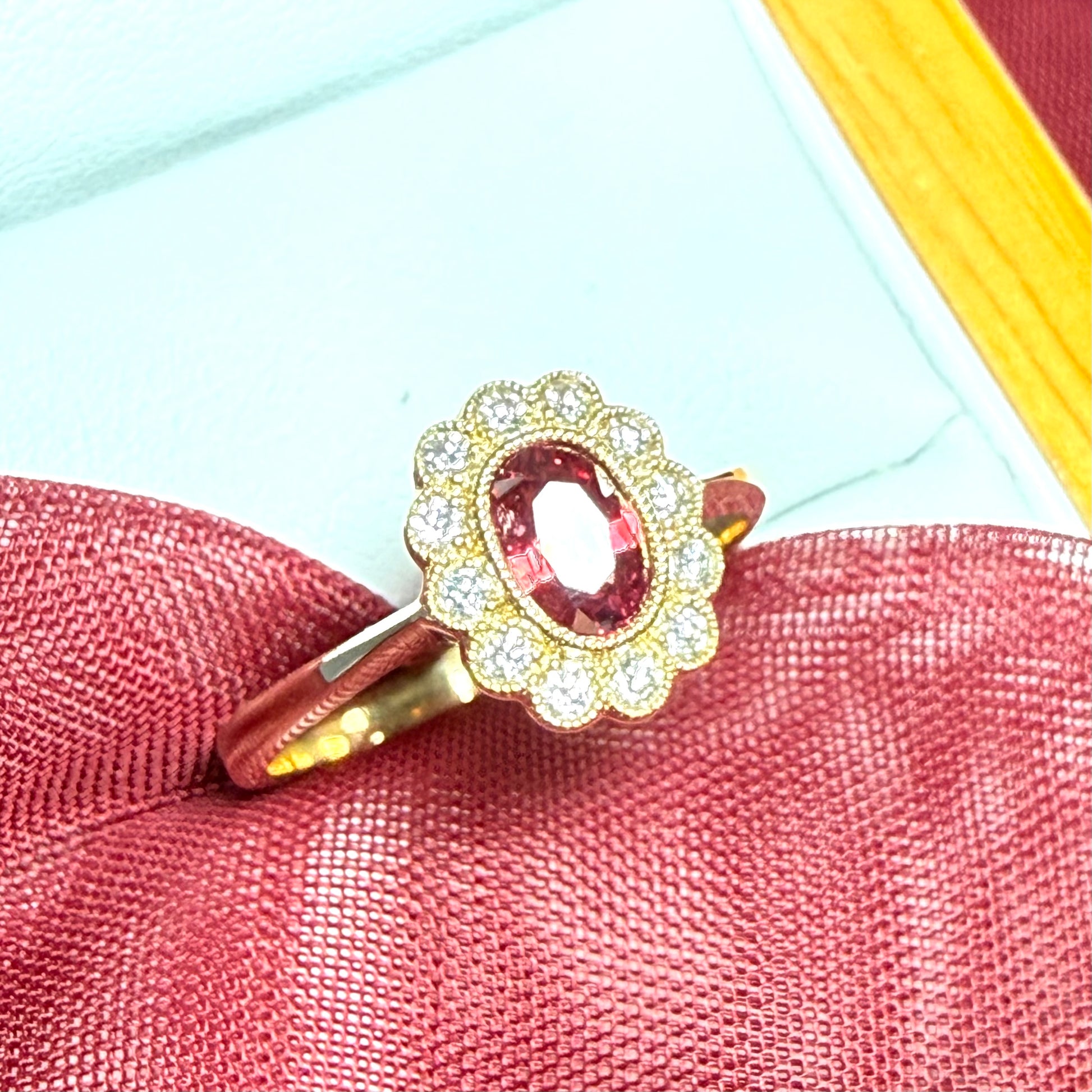 Oval shaped red real ruby and real diamond yellow gold cluster ring
