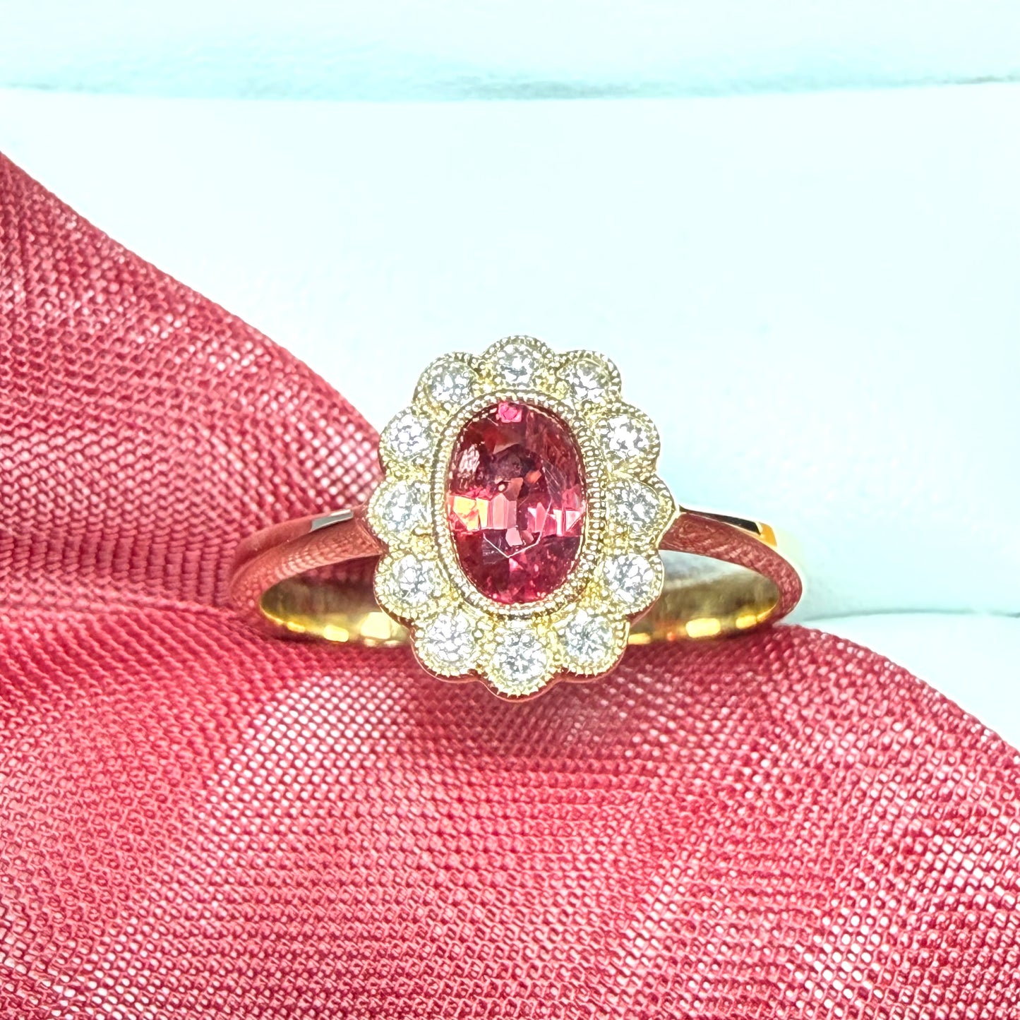 Oval shaped red real ruby and real diamond yellow gold cluster ring