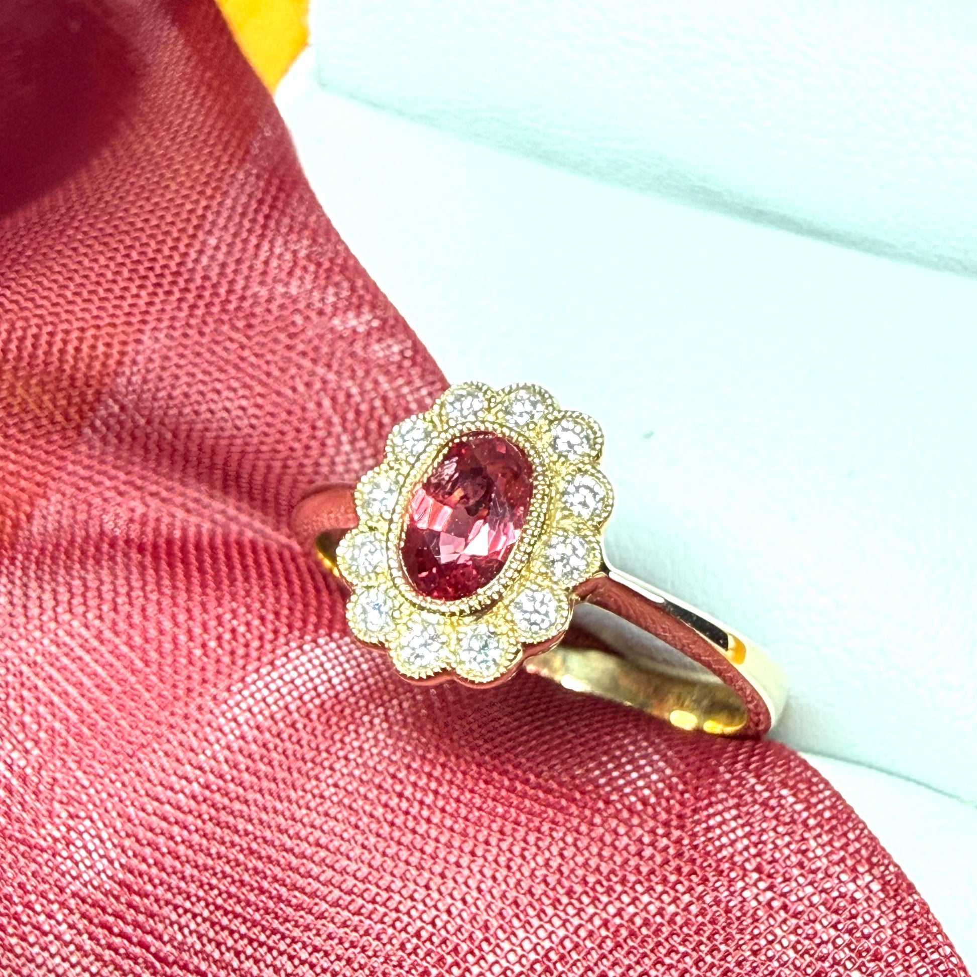 Oval shaped red real ruby and real diamond yellow gold cluster ring