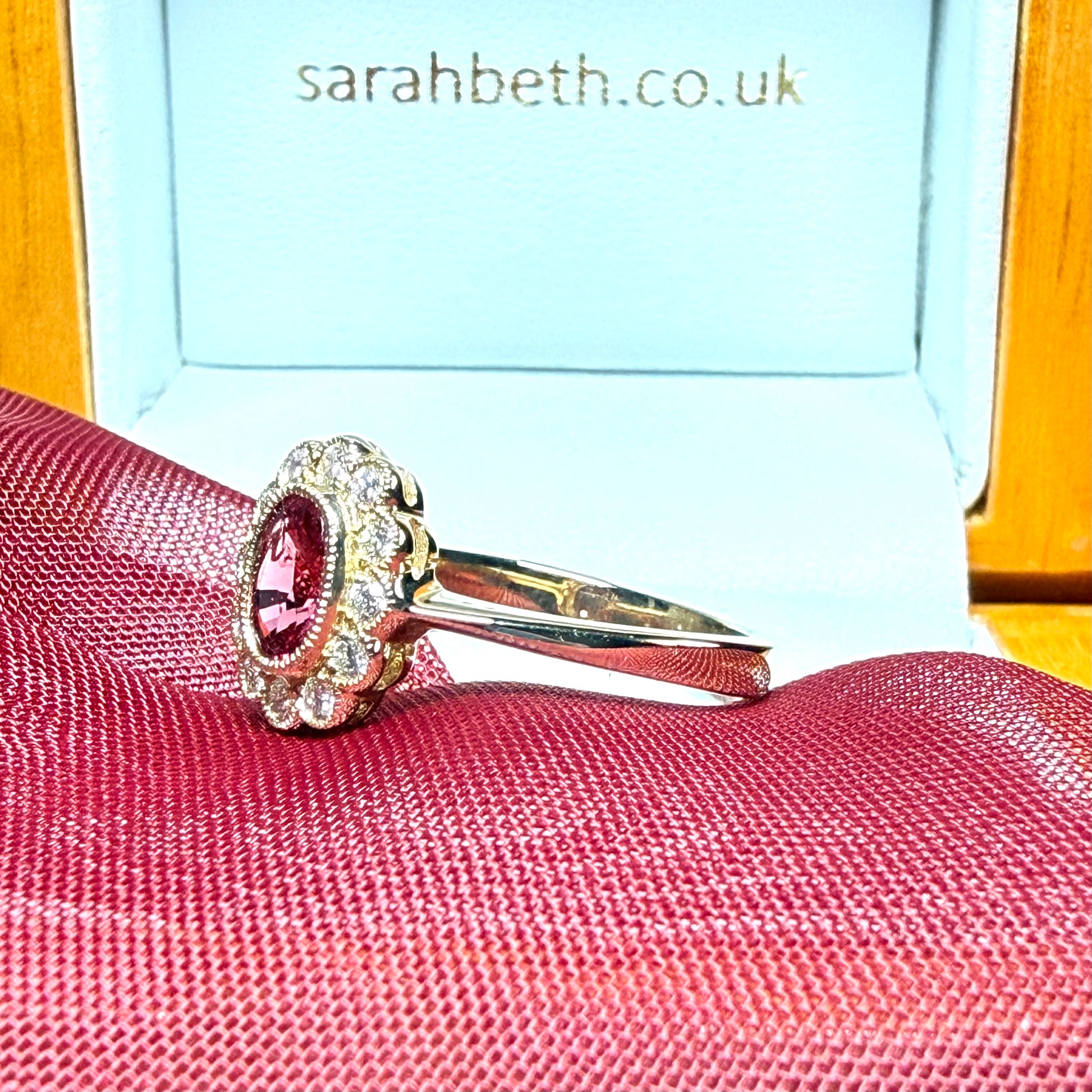 Oval shaped red real ruby and real diamond yellow gold cluster ring