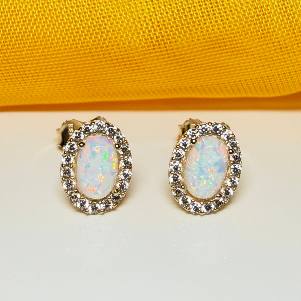 Oval shaped stud cluster earrings opal and cubic zirconia yellow gold