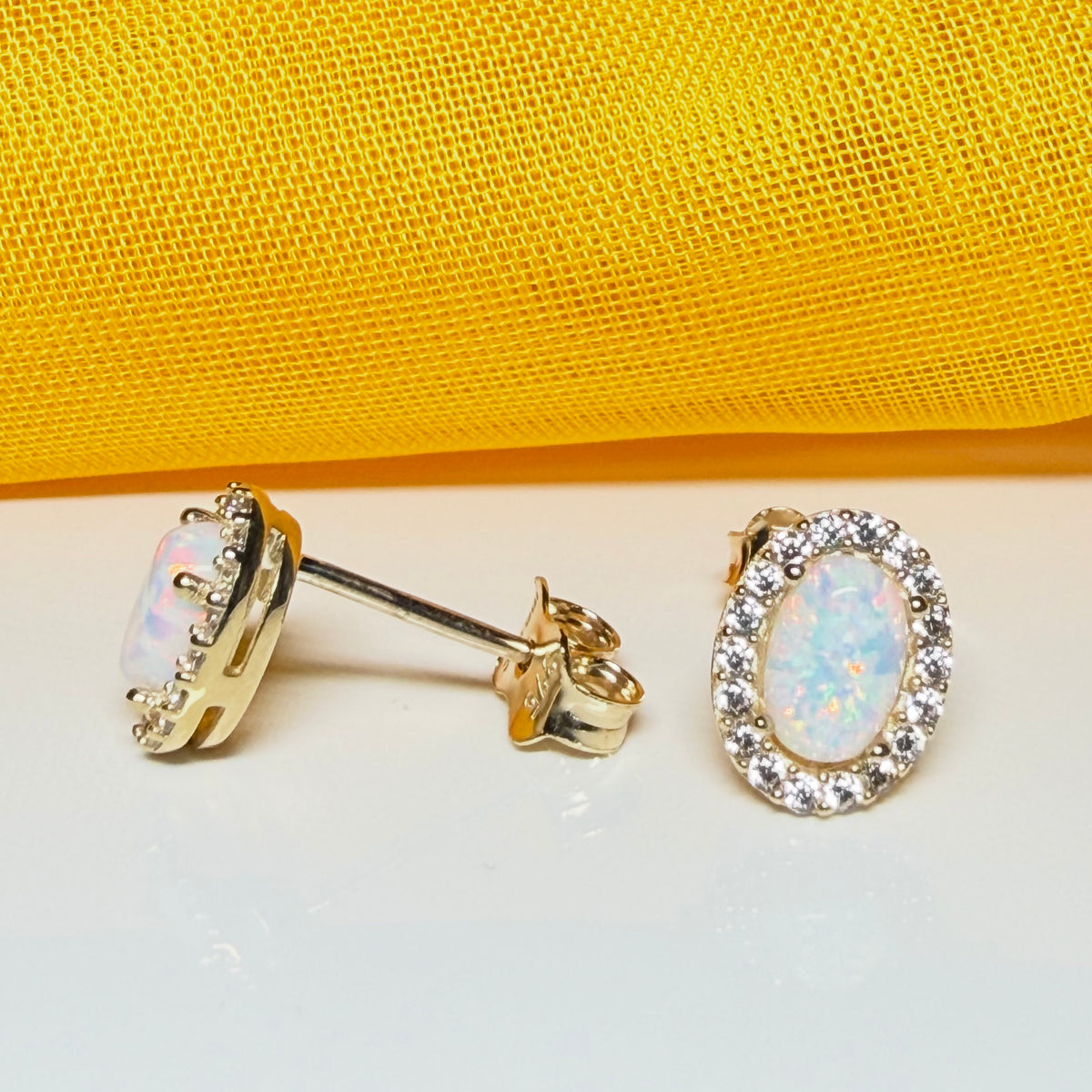 Oval shaped stud cluster earrings opal and cubic zirconia yellow gold