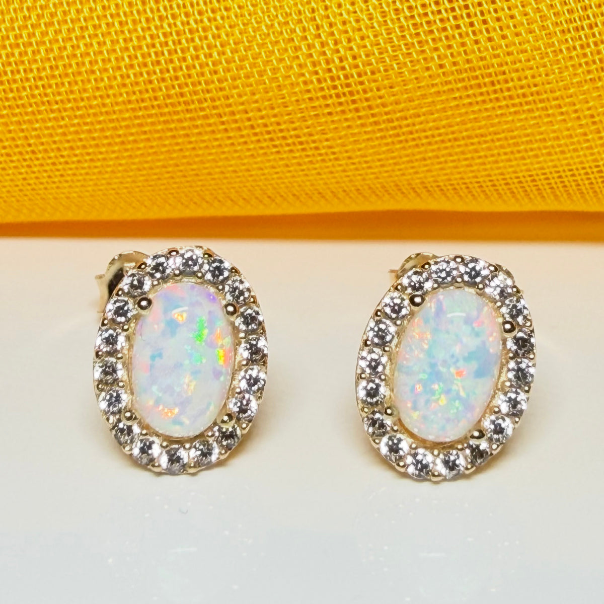 Oval shaped stud cluster earrings opal and cubic zirconia yellow gold