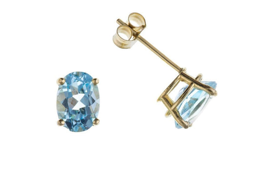 Oval blue topaz stud earrings yellow gold