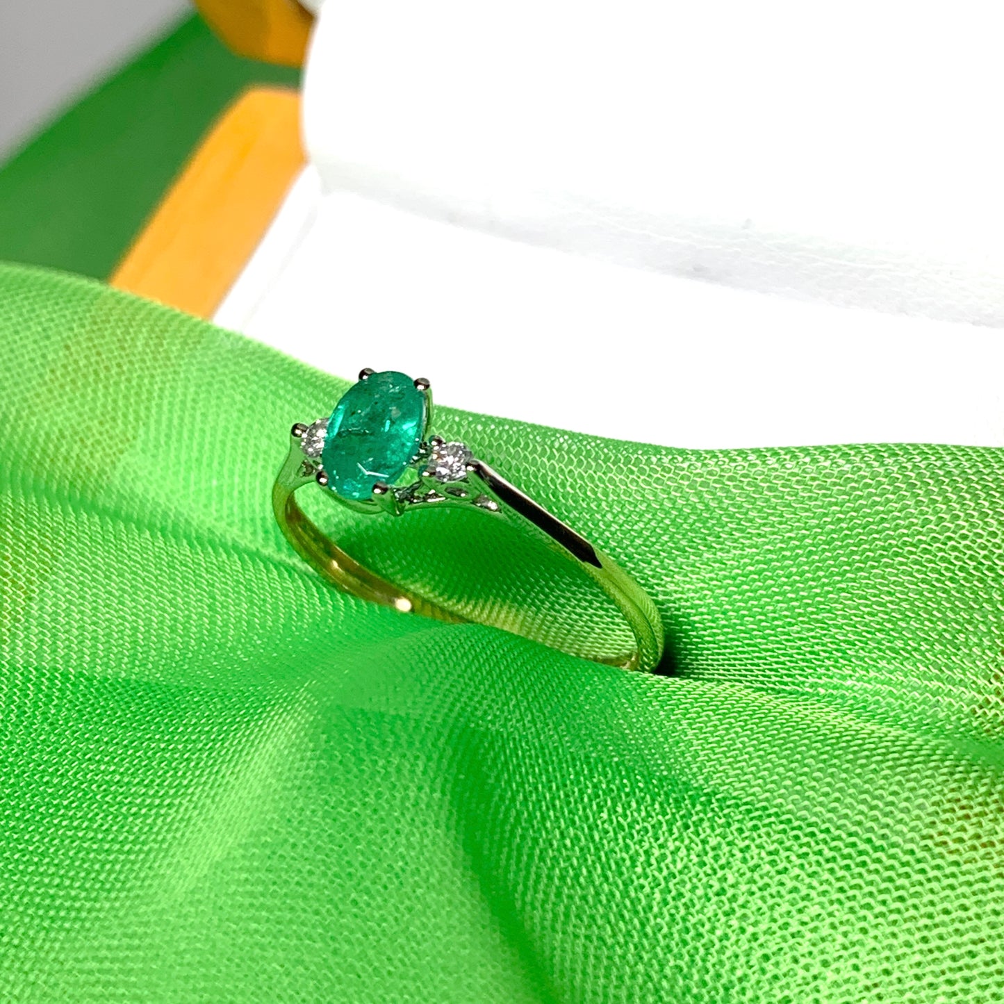 Oval real green emerald and diamond yellow gold trilogy dress ring