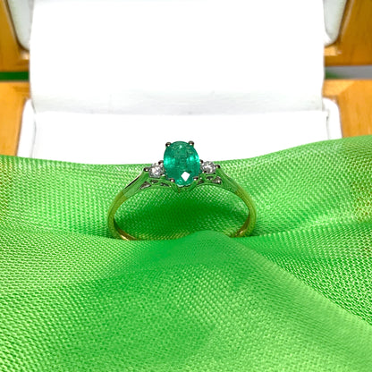 Oval real green emerald and diamond yellow gold trilogy dress ring