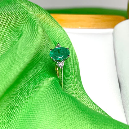 Oval real green emerald and diamond yellow gold trilogy dress ring