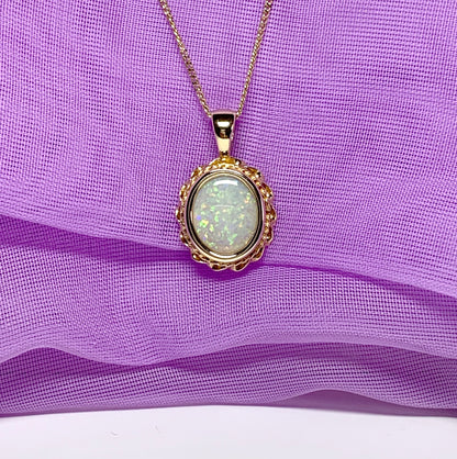 Oval real opal yellow gold necklace with a roped edge