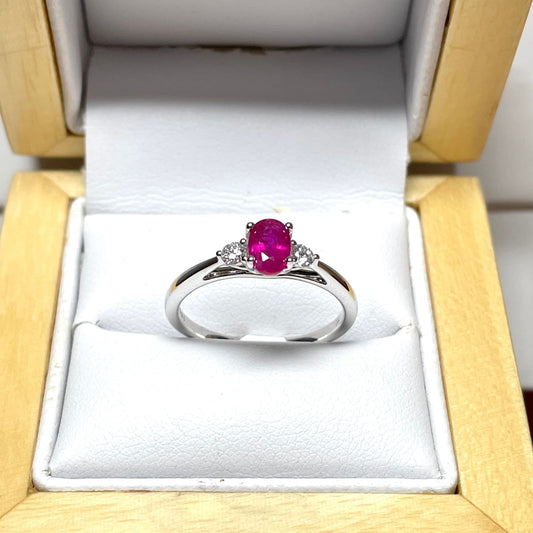 Oval ruby red and diamond white gold dress ring