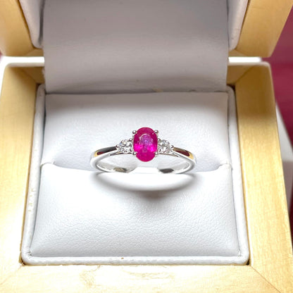 Oval ruby red and diamond white gold dress ring