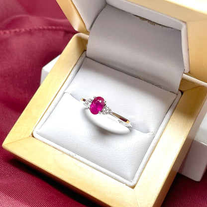 Oval ruby red and diamond white gold dress ring