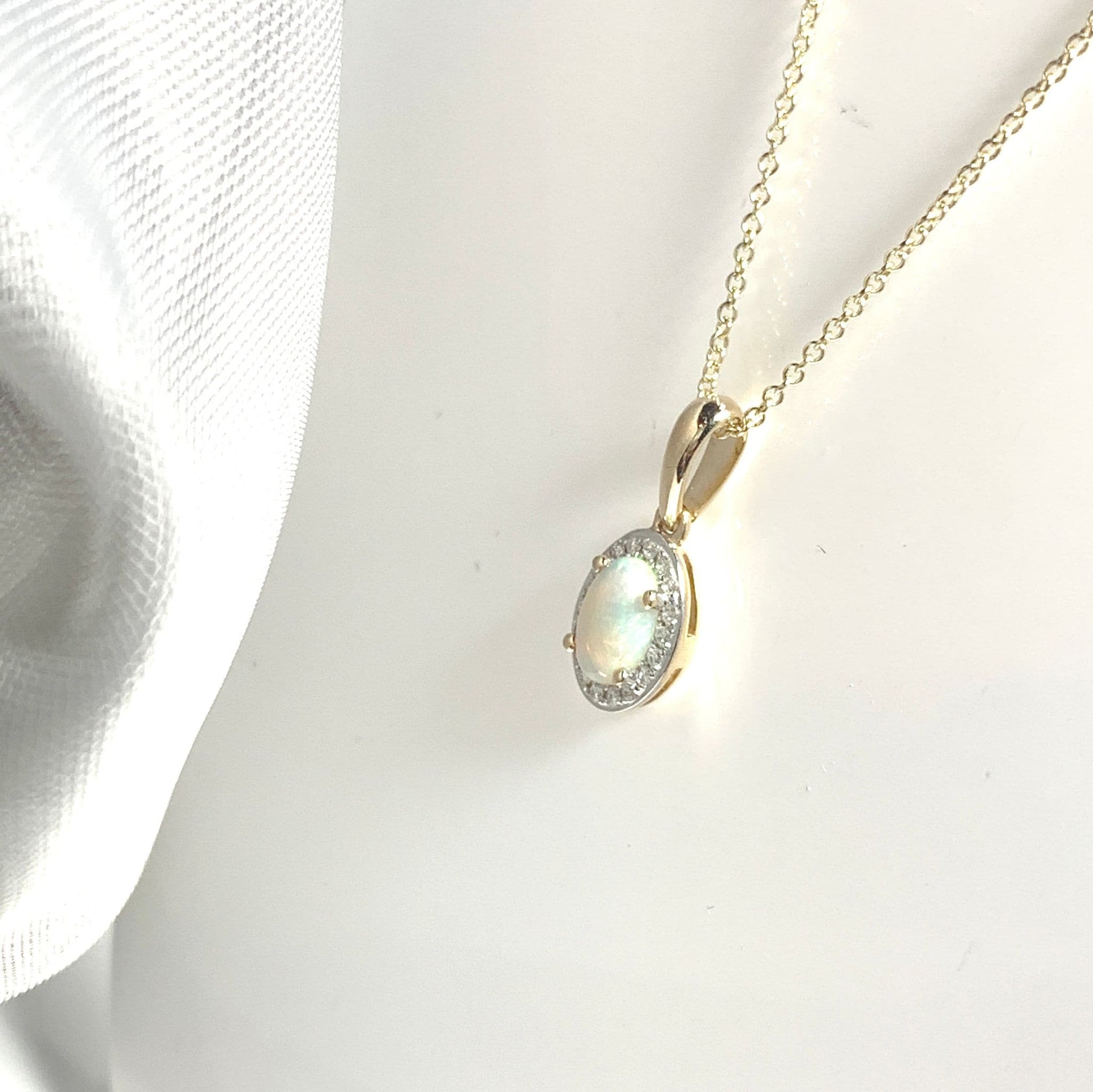 Oval shaped opal and diamond yellow gold cluster necklace