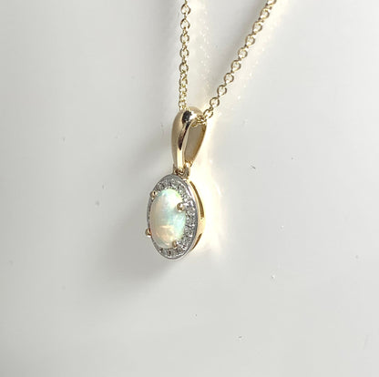 Oval shaped opal and diamond yellow gold cluster necklace