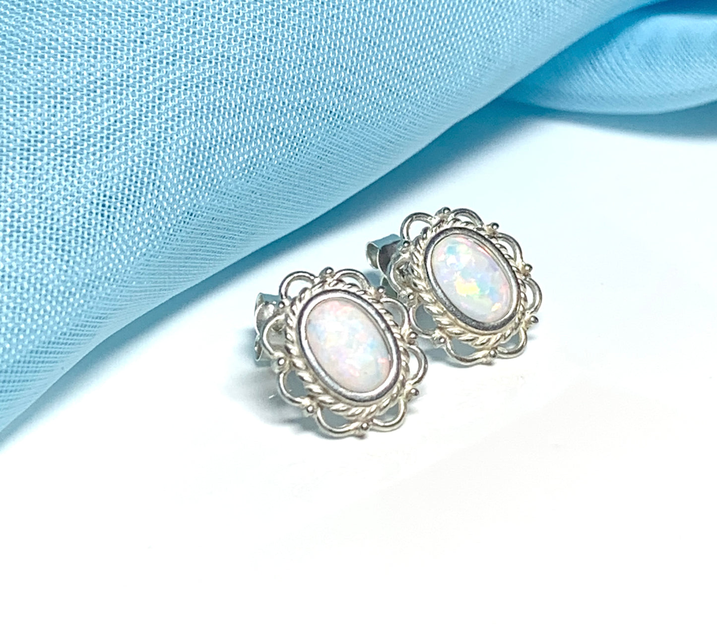 Fancy oval sterling silver opal stud earrings
