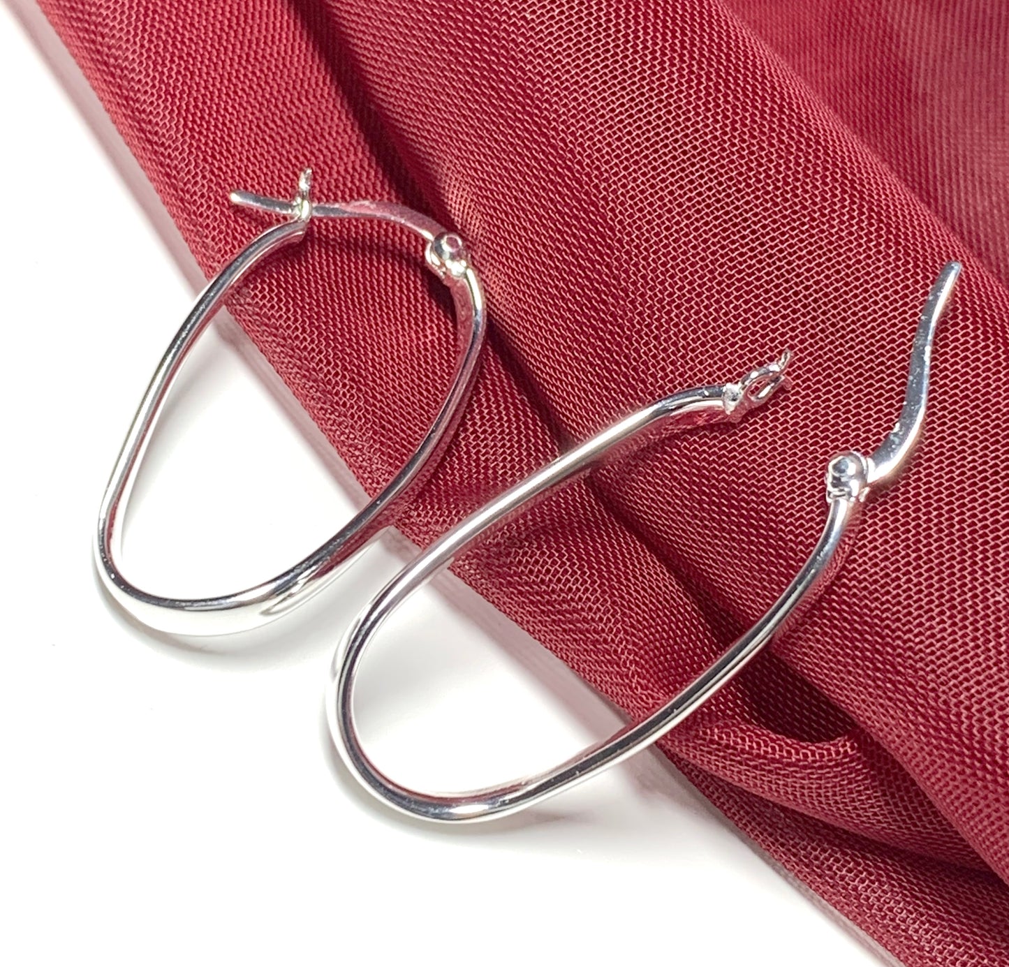 Oval twisted polished hoop earrings sterling silver