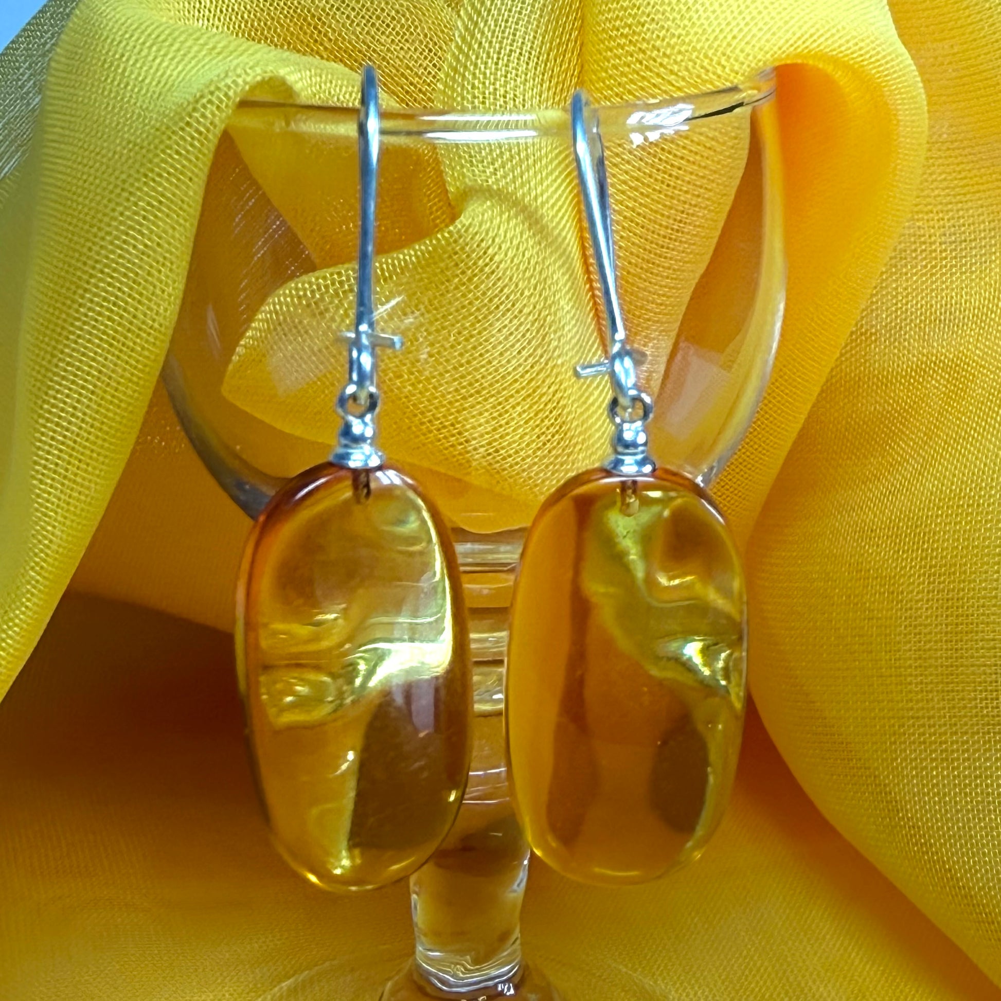 Pair of real amber drop earrings oval shaped sterling silver wire fastenings