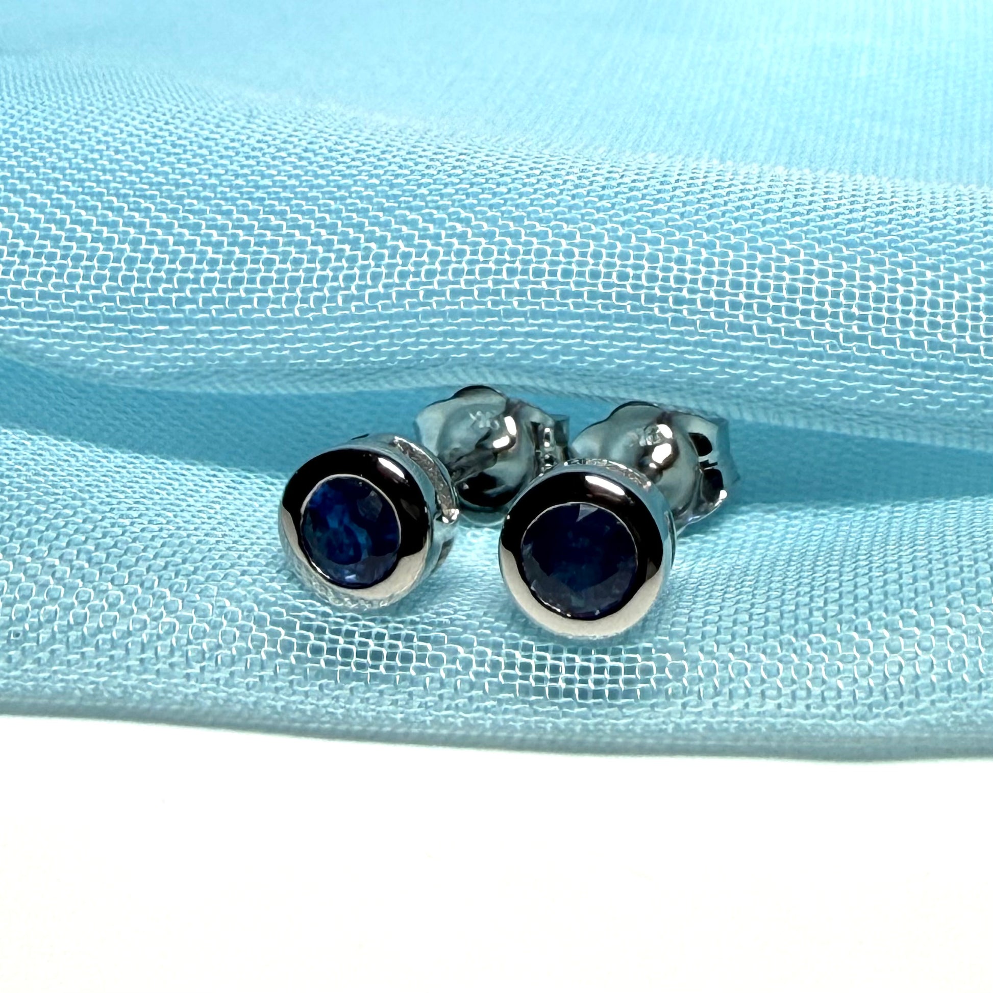 Pair of real blue sapphire earrings round white gold stud smooth rubbed over setting