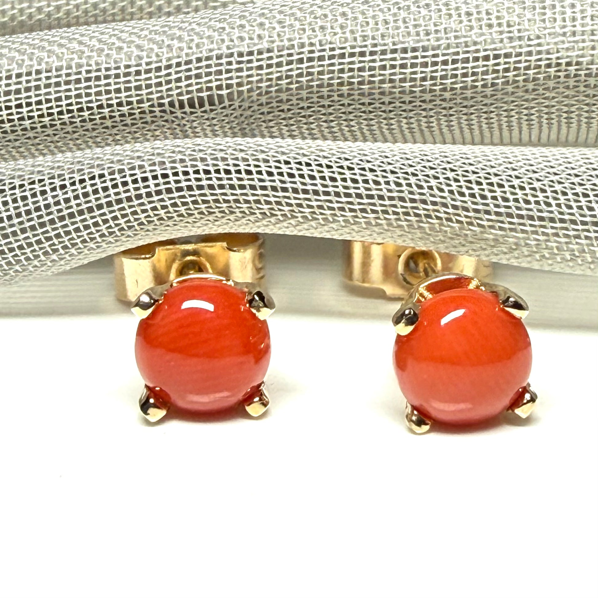 A pair of real dark coral yellow gold round clawed set stud earrings, simply gorgeous