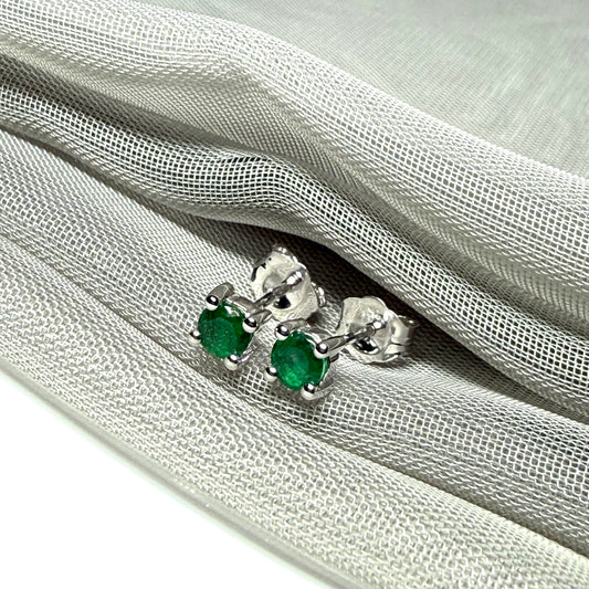 A pair of real green emerald earrings round white gold claw set studs