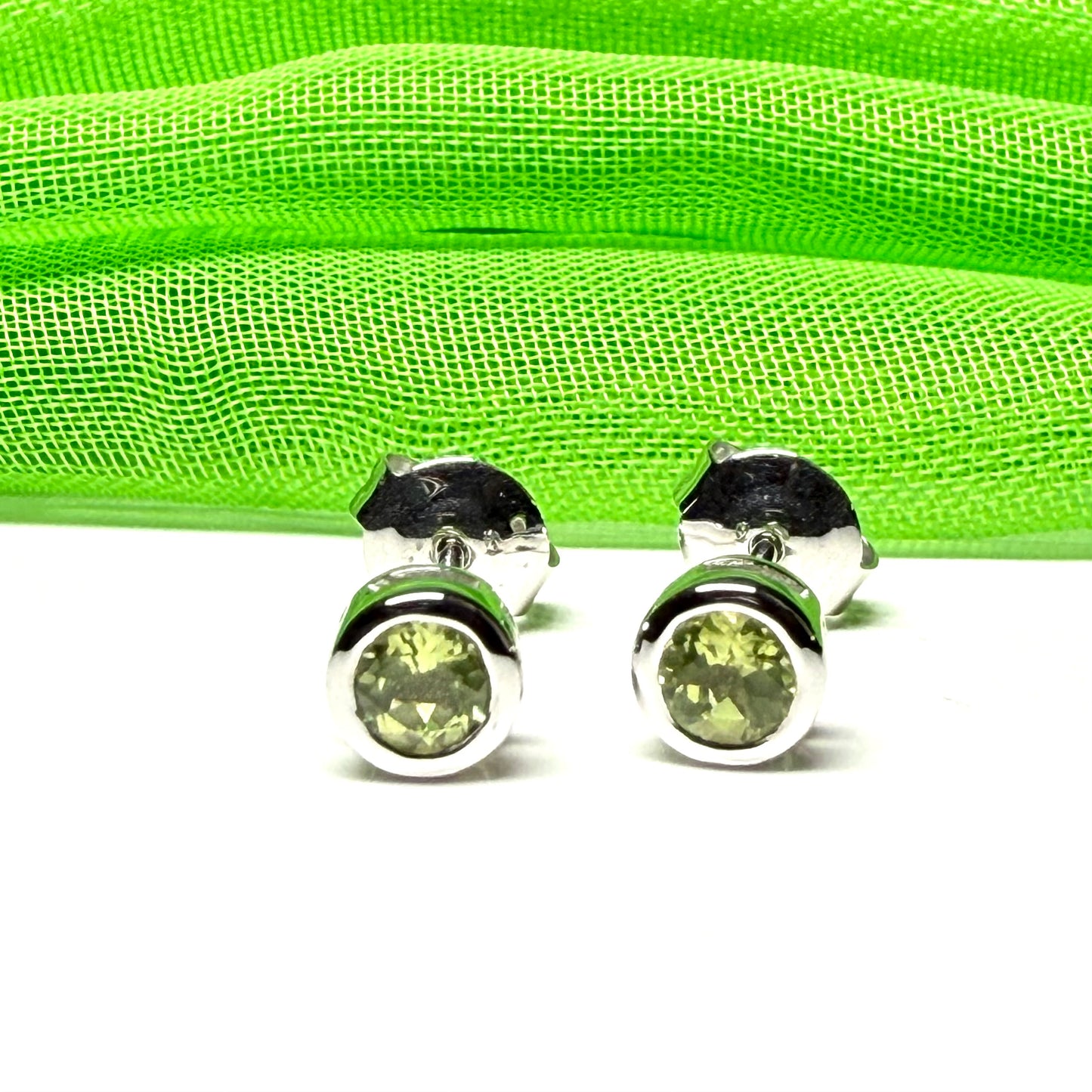 Pair of real green peridot earrings round white gold stud smooth rubbed over setting