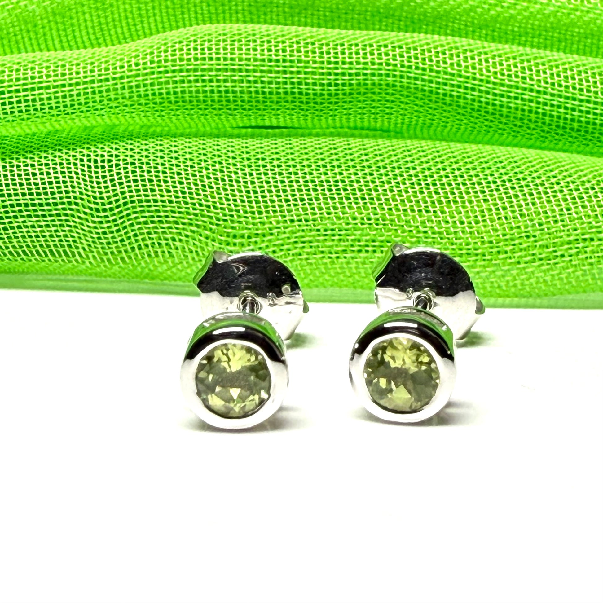 Pair of real green peridot earrings round white gold stud smooth rubbed over setting
