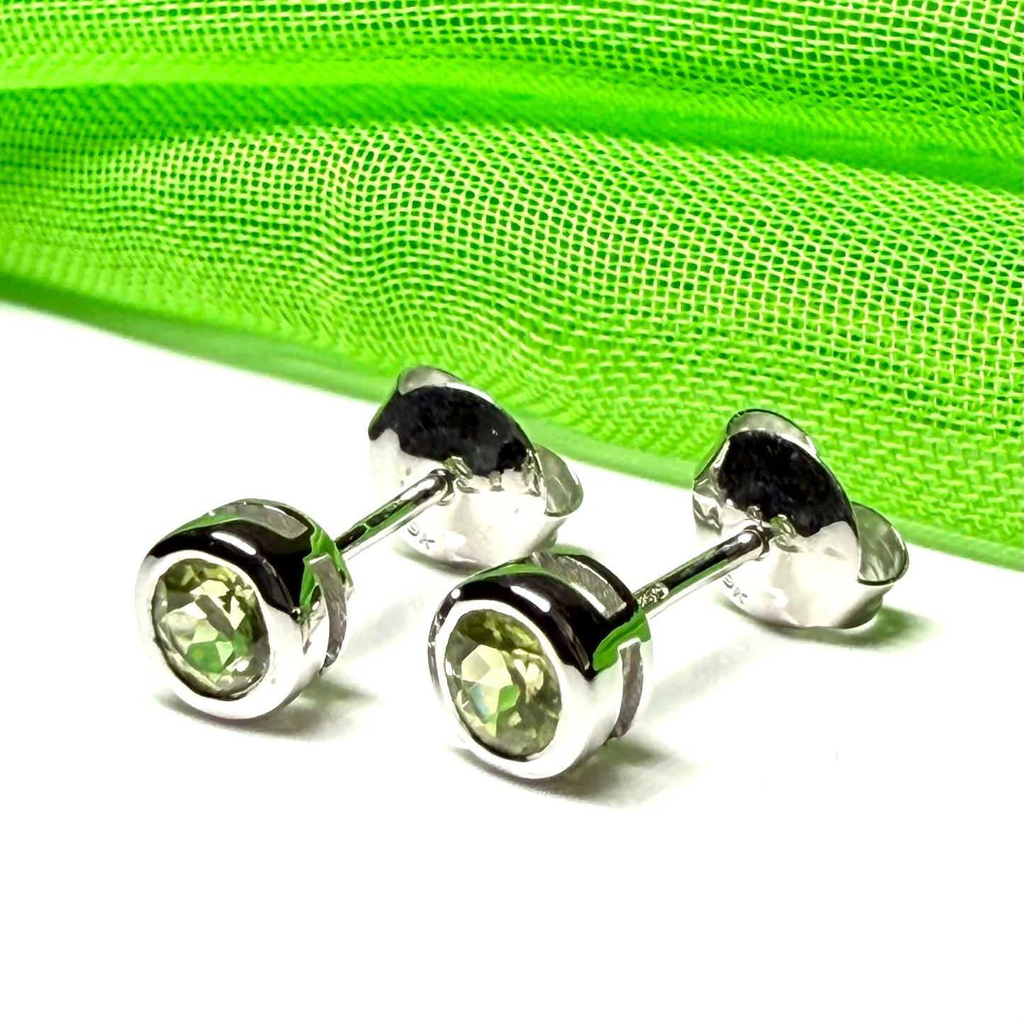 Pair of real green peridot earrings round white gold stud smooth rubbed over setting