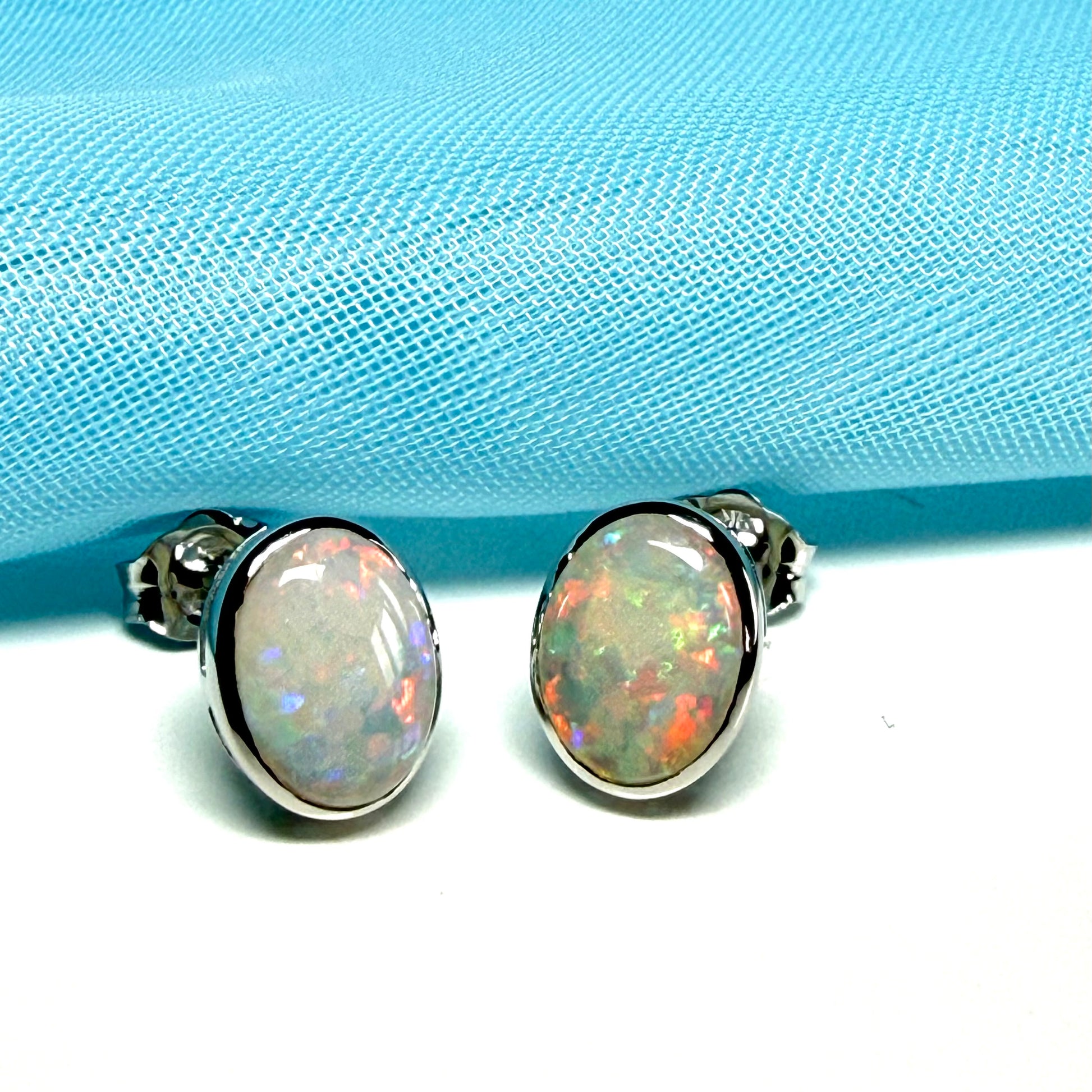 Pair of real opal white gold oval stud earrings