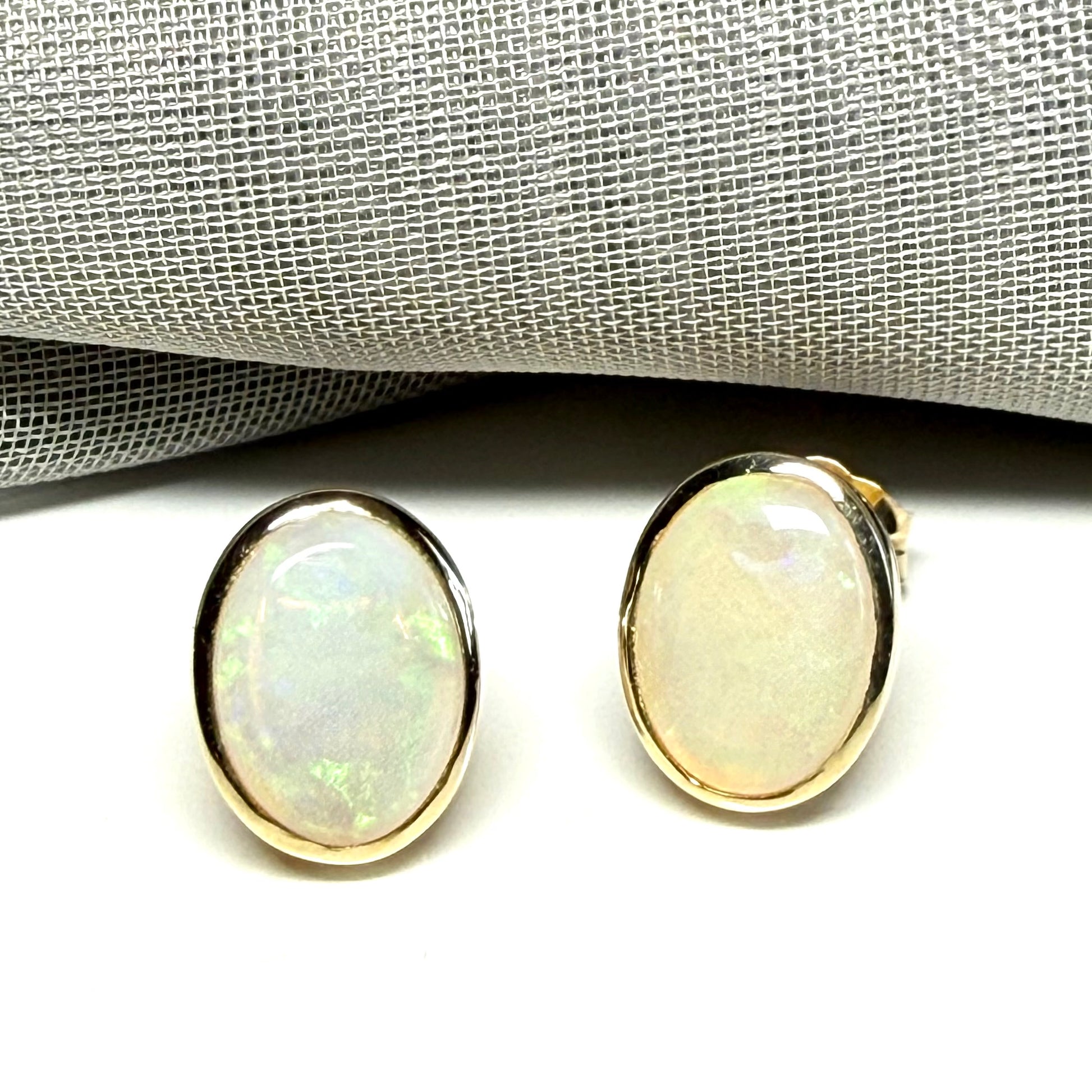 Pair of real opal yellow gold oval stud earrings