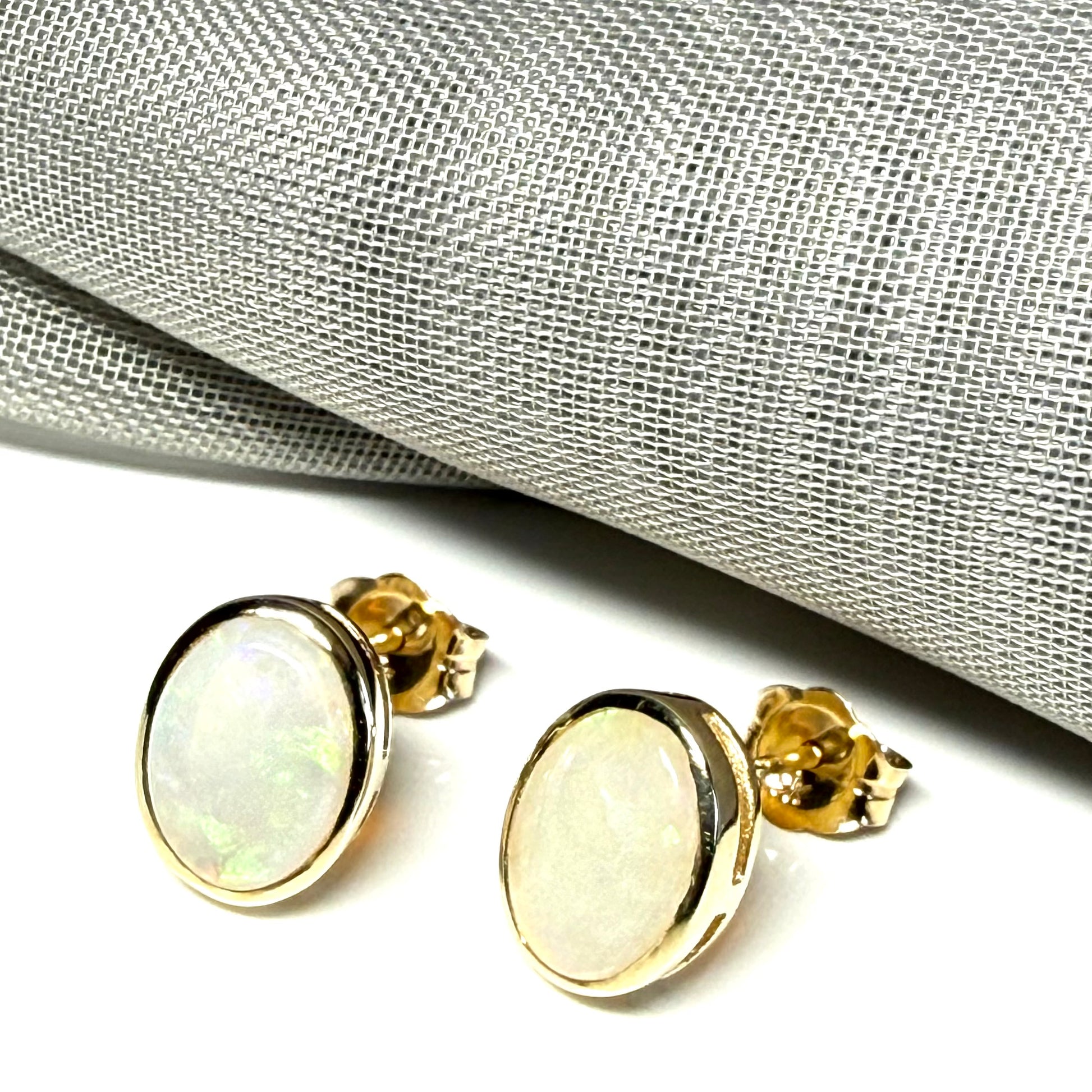 Pair of real opal yellow gold oval stud earrings