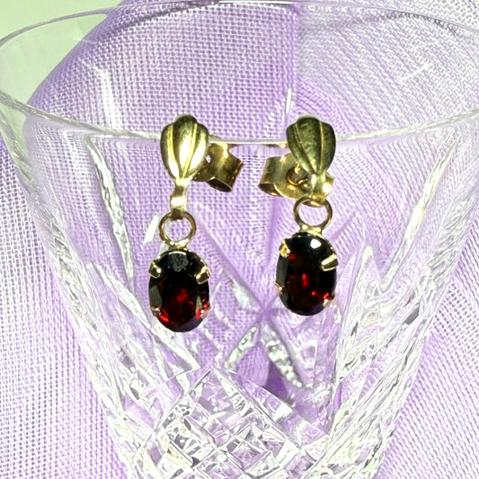 A pair of real red garnet drop earrings oval shaped yellow gold